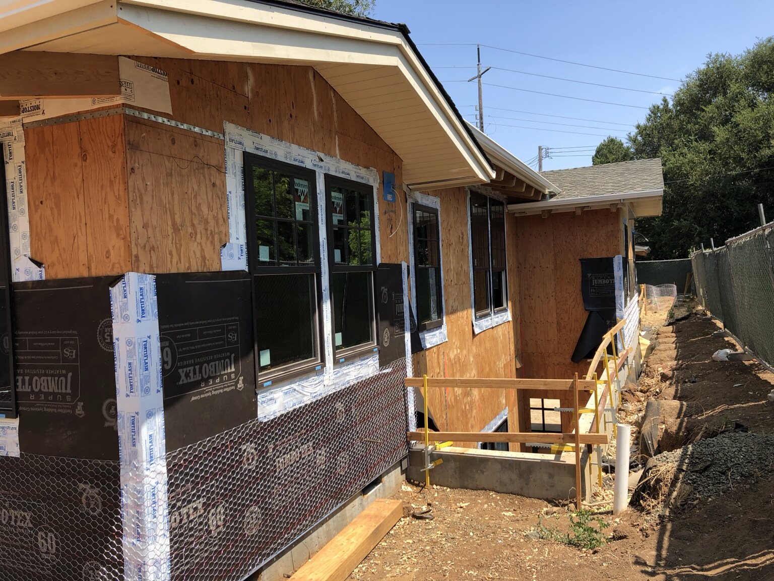 Side elevation showing installed windows and weather-resistant exterior assembly