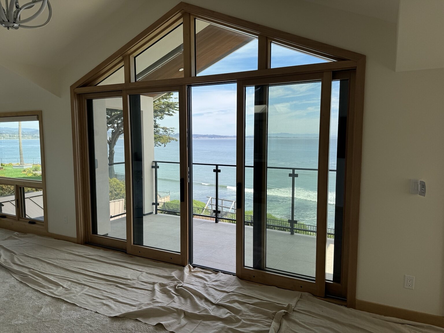 Ocean view through custom doors and windows at the Opal Cliffs home